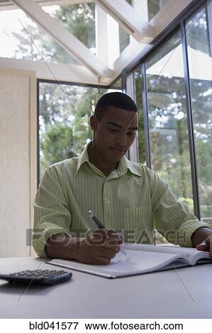 African man writing in notebook View Large Photo Image Stock Photo - African man writing in notebook. Fotosearch