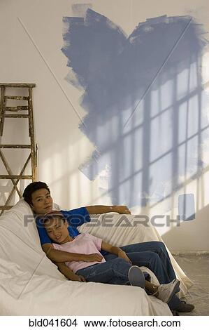 Asian couple in partially painted room View Large Photo Image Picture - Asian couple in partially painted room. Fotosearch