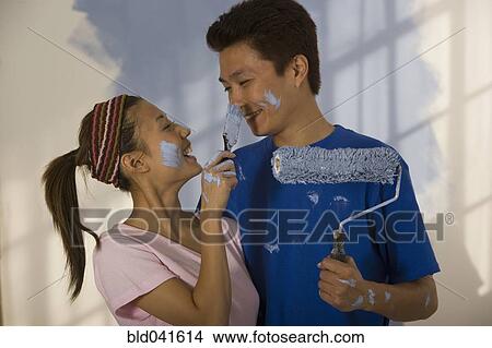 Picture - Asian couple painting and being playful. Fotosearch