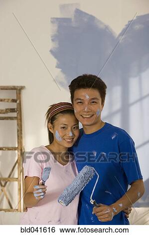 Asian couple painting interior of house View Large Photo Image Stock Photograph - Asian couple painting interior of house. Fotosearch