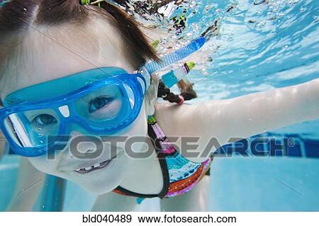 Stock Photo - Asian girl swimming under water. Fotosearch