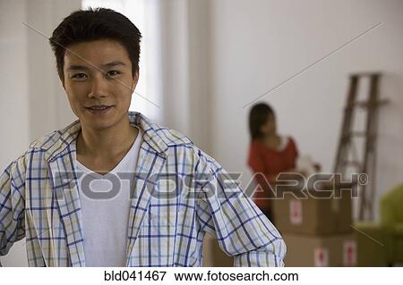 Asian man wife with packing in background View Large Photo Image Stock Photo - Asian man wife with packing in background. Fotosearch