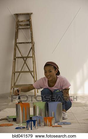 Stock Photo - Asian woman with painting supplies. Fotosearch