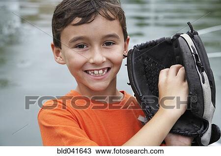 Stock Image - Boy wearing baseball mitt. Fotosearch