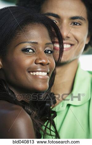 Stock Image - Close up of South American couple smiling. Fotosearch