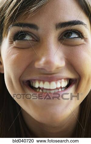 Stock Image - Close up of South American woman smiling. Fotosearch