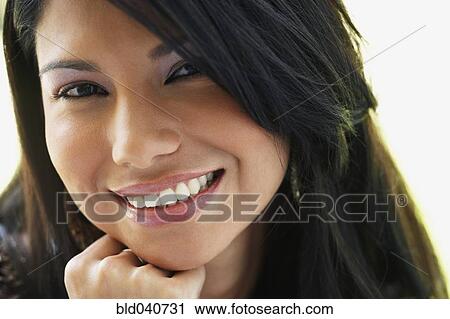 Stock Image - Close up of South American woman smiling. Fotosearch