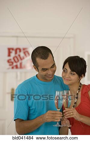 Picture - Couple toasting in new house. Fotosearch