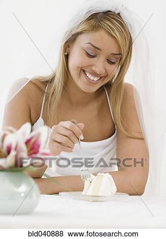 Hispanic bride eating cake View Large Photo Image Stock Photo - Hispanic bride eating cake. Fotosearch