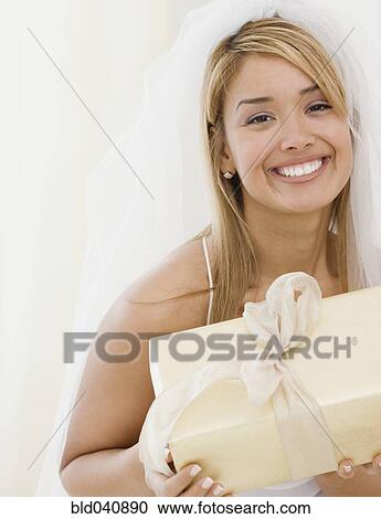 Hispanic bride holding gift View Large Photo Image Stock Image - Hispanic bride holding gift. Fotosearch
