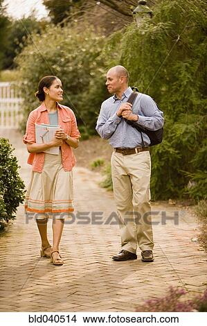 Picture - Hispanic couple walking in park. Fotosearch