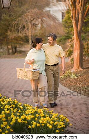 Hispanic couple walking in park View Large Photo Image Stock Photo - Hispanic couple walking in park. Fotosearch