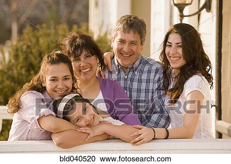 Hispanic family hugging on porch View Large Photo Image Stock Image - Hispanic family hugging on porch. Fotosearch