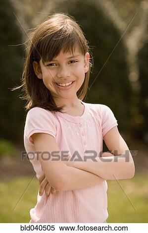 Hispanic girl with arms crossed View Large Photo Image Stock Photography - Hispanic girl with arms crossed. Fotosearch