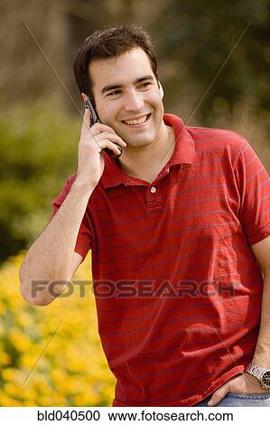 Stock Image - Hispanic man talking on cell phone. Fotosearch