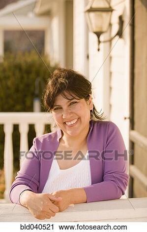 Hispanic woman leaning on porch railing View Large Photo Image Stock Image - Hispanic woman leaning on porch railing. Fotosearch