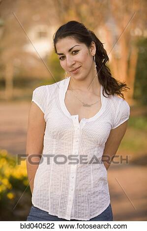 Hispanic woman with hands behind back View Large Photo Image Stock Image - Hispanic woman with hands behind back. Fotosearch