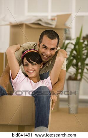 Man pushing wife in moving box View Large Photo Image Stock Image - Man pushing wife in moving box. Fotosearch