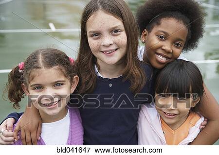 Stock Photo - Multi-ethnic children hugging. Fotosearch