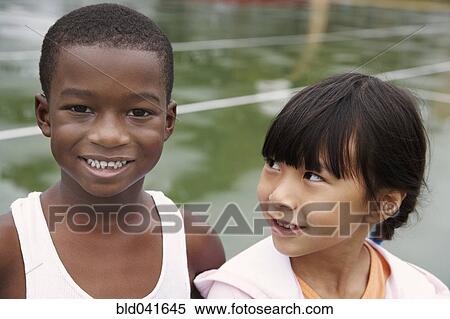 Stock Photography - Multi-ethnic children on playground. Fotosearch