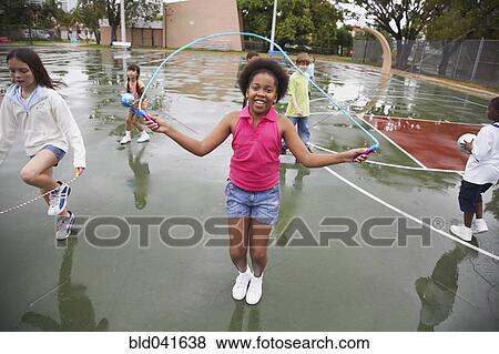 Stock Photo - Multi-ethnic children playing in urban area. Fotosearch