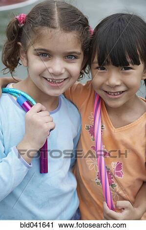 Multi-ethnic girls hugging View Large Photo Image Stock Image - Multi-ethnic girls hugging . Fotosearch