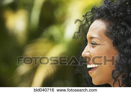 Stock Photograph - Profile of South American woman laughing. Fotosearch