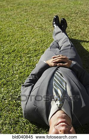 South American businessman laying in grass View Large Photo Image Stock Photography - South American businessman laying in grass. Fotosearch