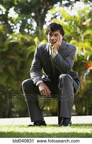 South American businessman sitting in park View Large Photo Image Stock Image - South American businessman sitting in park. Fotosearch