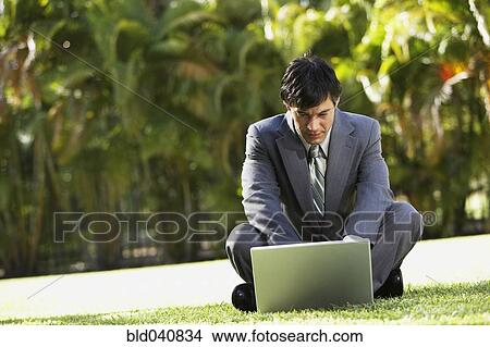 Picture - South American businessman typing on laptop. Fotosearch