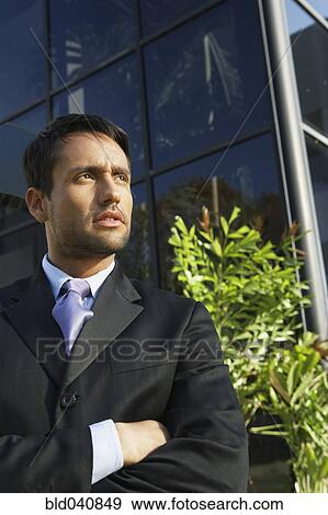 Stock Photo - South American businessman with arms crossed. Fotosearch