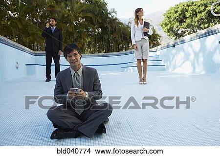 South American businesspeople in empty swimming pool View Large Photo Image Picture - South American businesspeople in empty swimming pool. Fotosearch