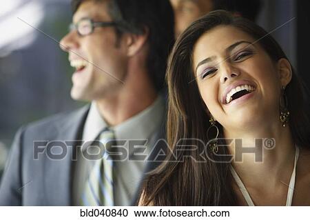 Stock Image - South American businesspeople laughing. Fotosearch