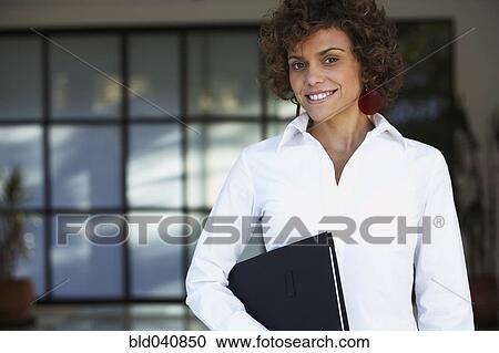 South American businesswoman holding folder View Large Photo Image Stock Image - South American businesswoman holding folder. Fotosearch