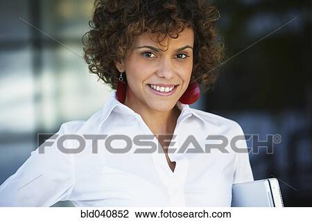 South American businesswoman holding laptop View Large Photo Image Stock Image - South American businesswoman holding laptop. Fotosearch