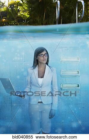 Stock Photography - South American businesswoman in swimming pool. Fotosearch