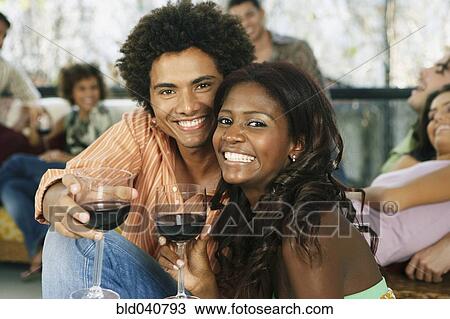 Stock Image - South American couple at party. Fotosearch
