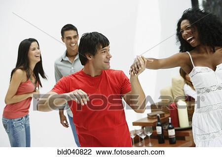 Stock Image - South American couple dancing at party. Fotosearch