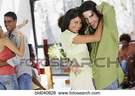 Stock Photo - South American couple dancing at party. Fotosearch