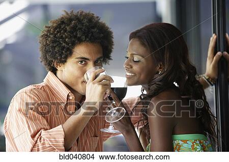 Picture - South American couple drinking wine. Fotosearch