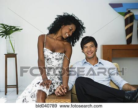Stock Photo - South American couple holding hands. Fotosearch
