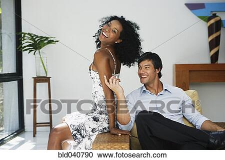 South American couple sitting on chair View Large Photo Image Stock Image - South American couple sitting on chair. Fotosearch