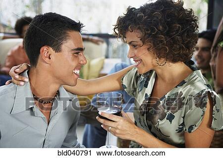 Stock Image - South American couple smiling at each other. Fotosearch