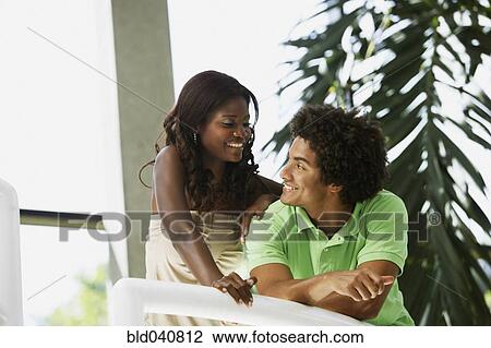 Stock Image - South American couple smiling at each other. Fotosearch