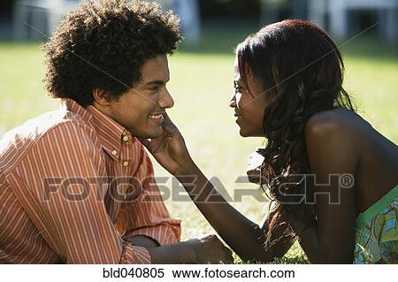 Stock Photography - South American couple smiling at each other. Fotosearch