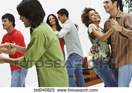 Stock Image - South American couples dancing at party. Fotosearch