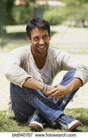 South American man sitting in grass View Large Photo Image Stock Photo - South American man sitting in grass. Fotosearch