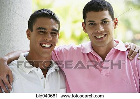Stock Image - South American men hugging. Fotosearch