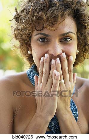 South American woman covering mouth View Large Photo Image Stock Photograph - South American woman covering mouth. Fotosearch