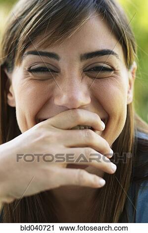 South American woman laughing and covering mouth View Large Photo Image Stock Image - South American woman laughing and covering mouth. Fotosearch